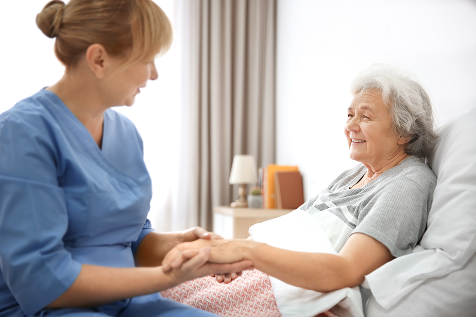 A female caregiver from Seagrape Home Health Care offering assistance to a senior patient in her Boca Raton home